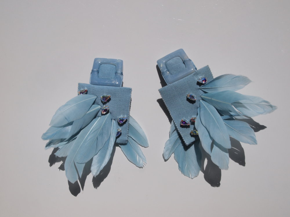 feather earrings in baby blue